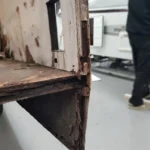 Close-up of damp damaged motorhome floor with delaminated plywood